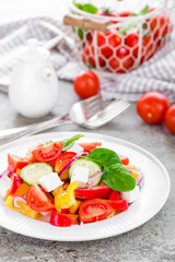 Tomato salad with fresh bell pepper, red onion and feta cheese. Healthy eating