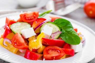 Tomato salad with fresh bell pepper, red onion and feta cheese. Healthy eating