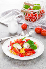 Tomato salad with fresh bell pepper, red onion and feta cheese. Healthy eating