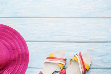 bright summer shoes on a light blue background and a pink hat.