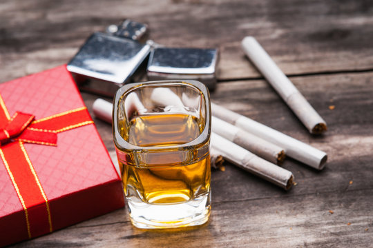 Tequila shot, cigarette lighter, gift box and cigarettes 