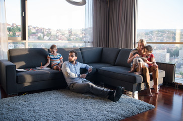 Happy Young Family Playing Together on sofa