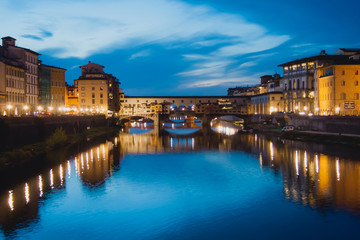 Obraz premium The Ponte Vecchio is a medieval stone closed-spandrel segmental arch bridge over the Arno River, in Florence, Italy.