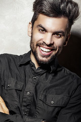 Obraz premium male portrait in black shirt with bristles, smiling
