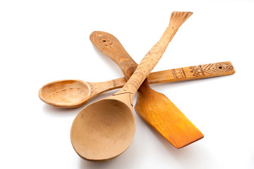 Wooden spoons and scapula on white background