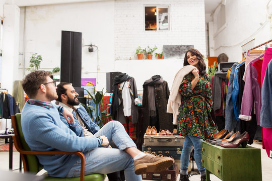 friends choosing clothes at vintage clothing store