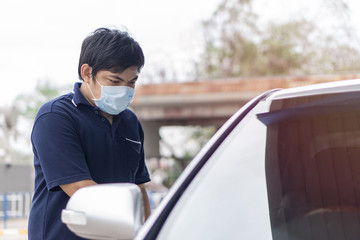 Robber and the car thief in a mask opens the door of the car and hijacks the car., Sick man with...
