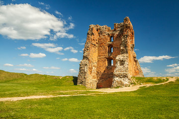 Ruins of an ancient medieval abandoned knight castle of the Grand Duchy of Lithuania, the largest state in Europe with gravel path in sunny summer day