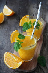 Orange smoothie on a wooden table