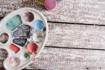 Paint on an old white wooden background.