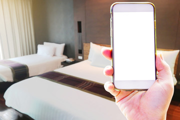 Hand holding smart phone with copy space on screen for finding hotel with application online - using application for finding hotel and choose the room