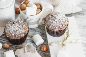 Cups with cacao and marshmallow, cupcakes and different decorations