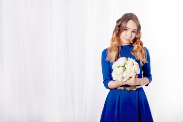 Girl with a bouquet on a curtain