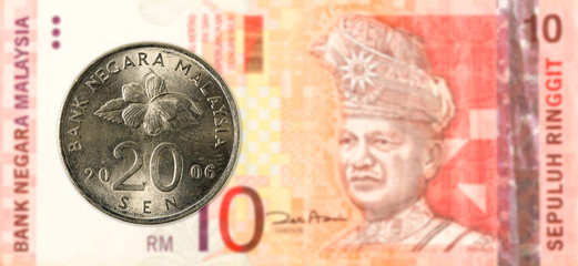 20 malaysian sen coin against 10 malaysian ringgit bank note obverse © Henning Marquardt