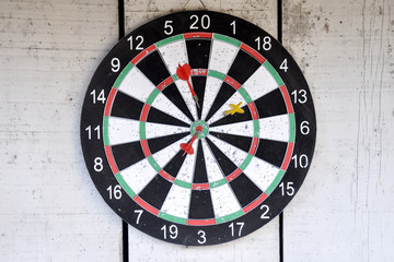 Dartboard hang on painted white color wood wall