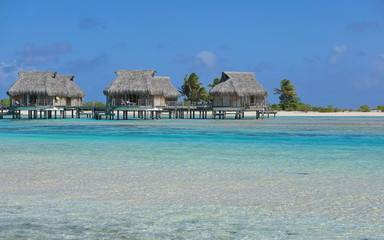 Tropical bungalows over water in the lagoon, Tikehau atoll, Tuamotus, French Polynesia, Pacific ocean, Oceania