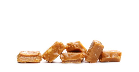 Caramels, pieces isolated on white background