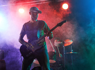 The guitarist performs on stage.