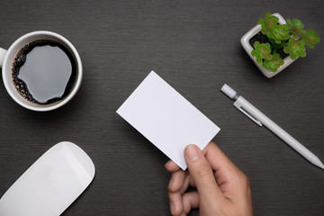 Obraz premium Mockup of white business cards in man's hand