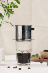 Coffee dripping in vietnamese style on wooden table