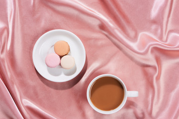 Cozy and tasty breakfast with coffee mug and macarons