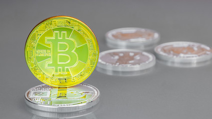 Close-up of a golden coin Bitcoin stands on a silver coin Lightcoin