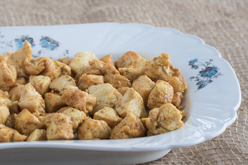  Pieces of chicken fried in spices on a white platter