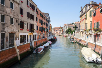 Fototapeta na wymiar VENICE, ITALY - May 18, 2017 : View of water street and old buildings in Venice on May 18, 2017. its entirety is listed as a World Heritage Site, along with its lagoon