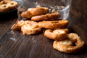 Palmier Cookies in Black Plate on Wooden Surface.