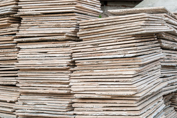 Stone tiles of different shades are stacked in a large pile. Background image. Building material.