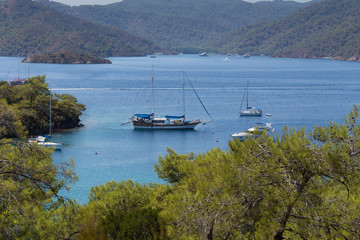 Excursion boats anchored in the bay of Yassica island, near Fethiye, in the Aegean sea, Turkey.