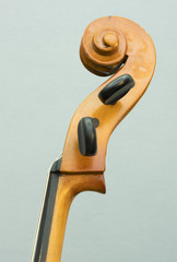 closeup of vintage string instrument cello with snares and scroll © ahavelaar