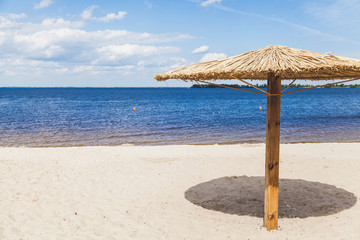 Sunshade on sandy beach on summer day