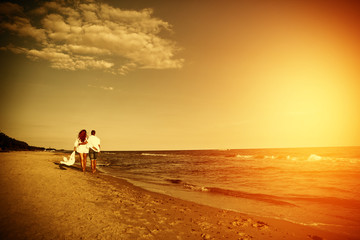 Two lovers on beach and sunset time 