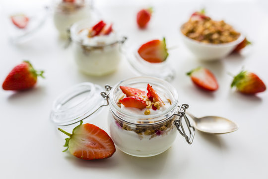 Delicious yogurt with e fresh strawberries and granola. 