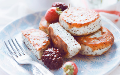 syrniki with poppy seeds on a wooden surface. concept of a healthy breakfast