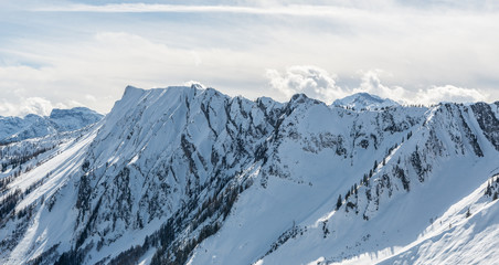 Fototapeta na wymiar Snow covered mountain range in winter