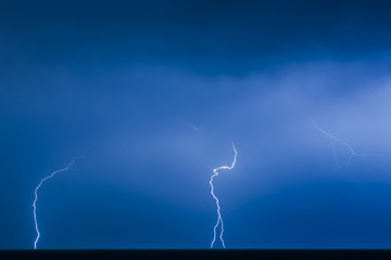 Naklejka na ściany i meble Lightning during a night thunderstorm