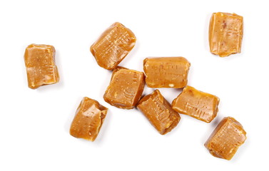 Caramels, pieces isolated on white background, top view