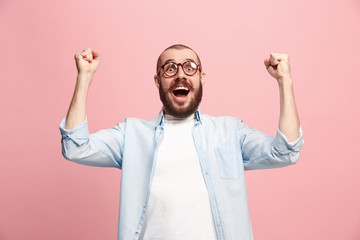 Winning success man happy ecstatic celebrating being a winner. Dynamic energetic image of male model