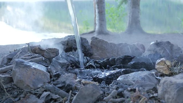 Fully putting out a camp fire to prevent forest fires
