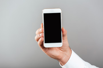 Close up of man showing blank screen mobile phone