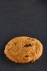 Lowkey picture of two chocolate cookies on dark background, close-up, shallow depth of field