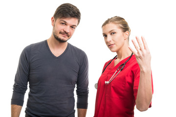 Male patient and female doctor showing number four.
