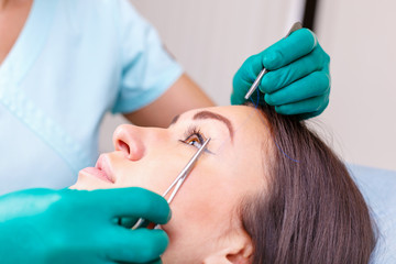 Doctor checking woman's face, the eyelid before plastic surgery, blepharoplasty.