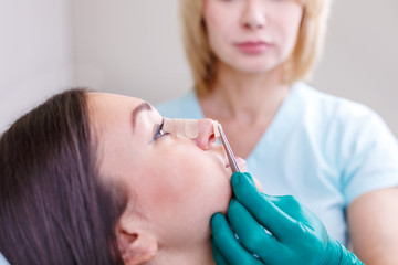 Doctor checking woman's face, the eyelid before plastic surgery, blepharoplasty.