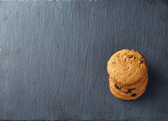 Lowkey picture of two chocolate cookies on dark background, close-up, shallow depth of field