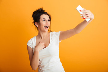 Shocked young woman using mobile phone.