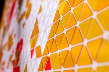 tessellation of a plane with yellow, orange and red colored triangles on a white background. mathematical and artistic game to cover a surface with geometric shapes. triangles in sequence as a code