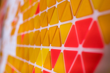 tessellation of a plane with yellow, orange and red colored triangles on a white background. mathematical and artistic game to cover a surface with geometric shapes. triangles in sequence as a code - Powered by Adobe